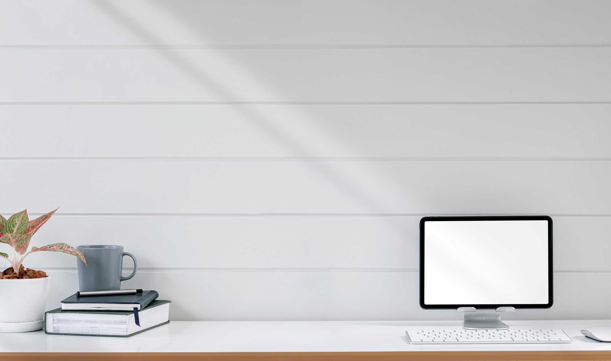 Mockup Bland Screen Tablet on Stand with Keyboard, Books and Hoo